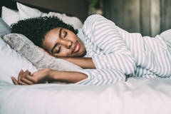 Image woman sleeping with curly hair against pillow