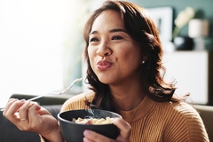 Image A woman eating food.