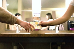 Image Hands handing off a period pad.