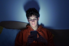 Image Teenager on his phone