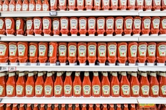 Image Kraft Heinz tomato sauce in bottles on the supermarket shelf.