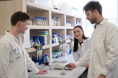 Image All G's lab and three scientists.