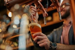 Image Bartender pouring beer in a pub