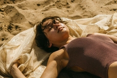 A woman lying on the beach.