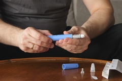 Man holding GLP-1 injection