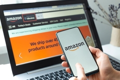 amazon website man holding phone with amazon logo