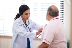 doctor checks heart of patient using stethoscope