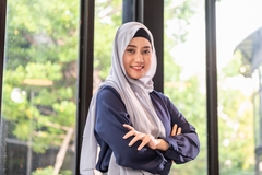 Image indonesian woman with hijab standing with arms in a cross