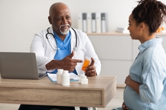 Doctor giving supplements to pregnant woman