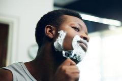 Image man shaving in bathroom