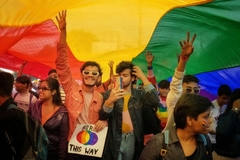 Image pride parade two men walking in front of flag