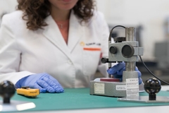 Image A person in a lab coat using a device