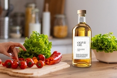 Image A bottle of olive oil next to a cutting board with vegetables