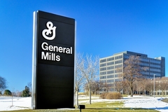 Image black and white symbol of general mills with a building in the background