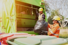 Image Men collecting packaging waste with truck.