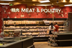 Southeast Asian consumers look at meat & poultry on supermarket shelf.