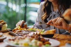 Image a woman's hand with festive food on the table