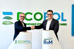 Image Two men shaking hands in front of a sign
