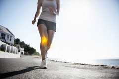 Image A woman runs with while her knee appears throught the skin as if an x ray.