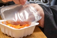 Image A child opening a container of food