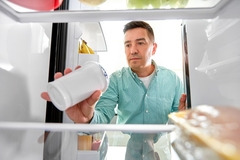 Image A consumer storing food in a fridge.