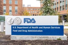 FDA signboard outside an orange building with trees