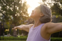 Image Asian woman middle aged happy doing yoga in park