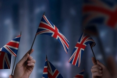 hands holding british flags