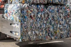 A truck with a large pile of plastic bottles