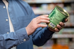 A buyer buying canned food.