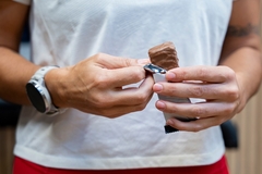 Image A person eating a protein bar.