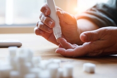 Image checking blood sugar levels with lancet