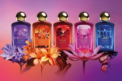 Image fragrance bottles line up against pink background