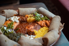Image Ethiopian dish with various dips and rolled up bread