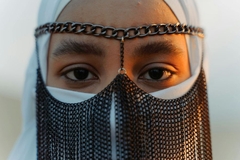 woman with traditional clothing and hijab at sunset