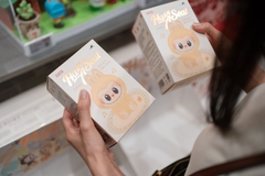 A person holding two boxes of Labubu
