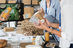 Image People holding plastic and paper packaging.