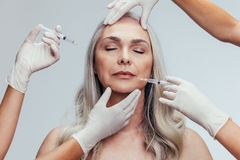 Image woman getting botox injection in face