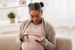 Pregnant woman taking supplements
