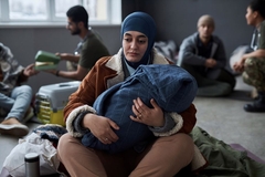 Woman holding child suffering from malnutrition