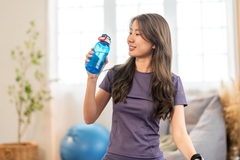 Active woman drinking clear protein