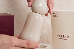 red packaging and white bottle with hand