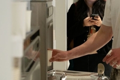 Image A person taking a cup of water from a machine