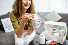 Image Woman taking gummy supplement