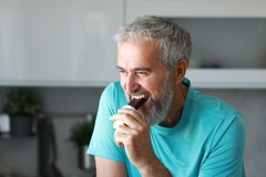 Image Senior man eating a nutrition bar