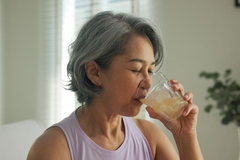Woman drinking probiotic beverage