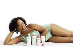 Image A woman lying down with Dove body products in front of her.