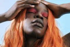 Image woman with orange hair in the sun