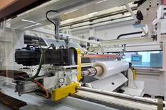 Image A machine with a roll of paper