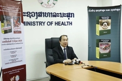 Image A person sitting at a desk at Laos Ministry of Health